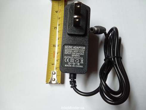 AC adapter, displayed next to a tape measure